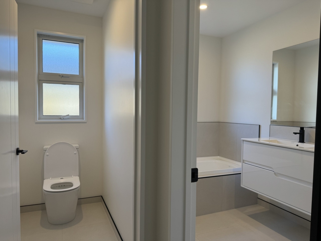 Bathroom in 3-bedroom 3-bathroom custom home at Acland Park, Rolleston